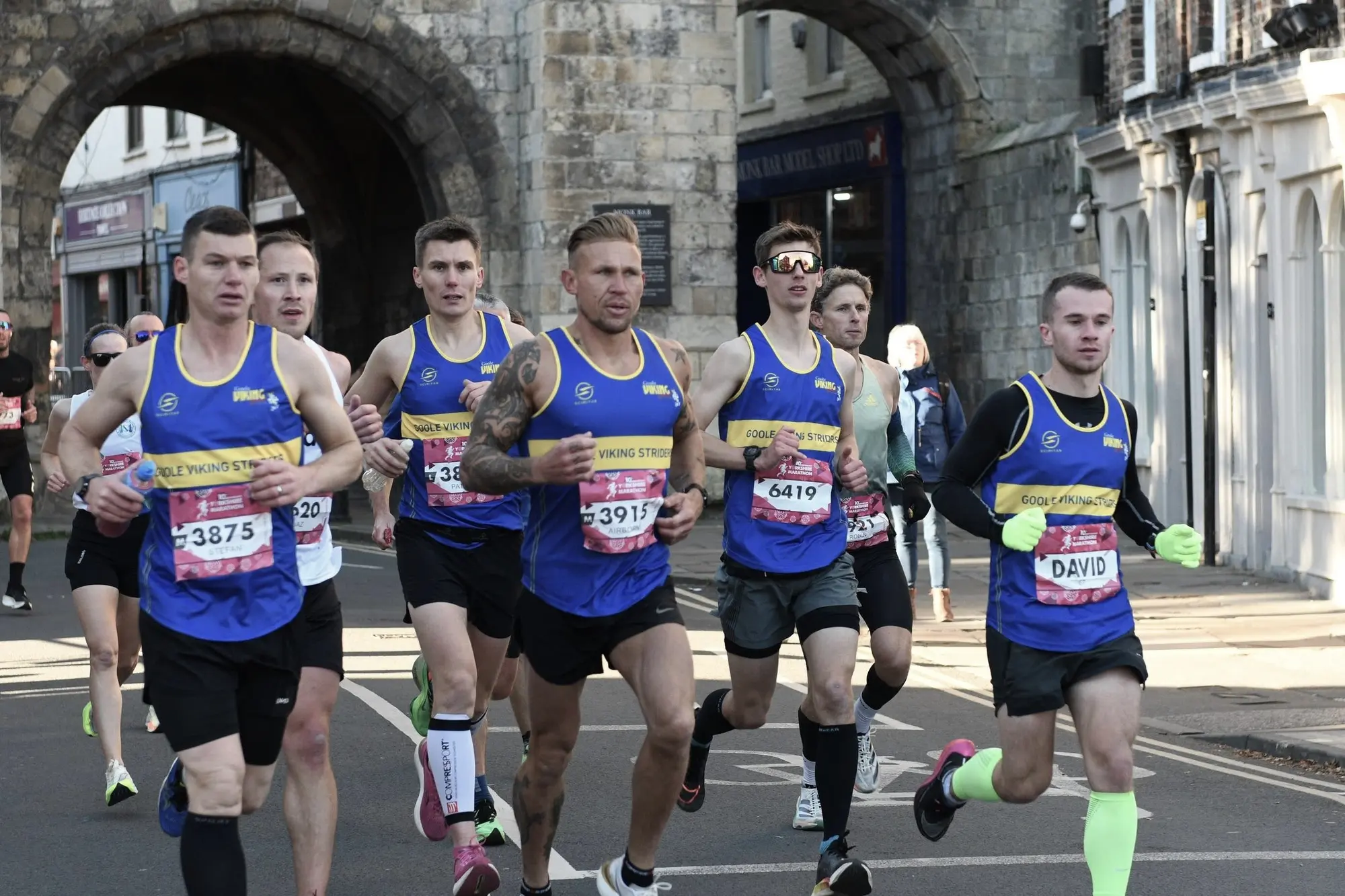 Goole Viking Striders members running together through York in club colours
